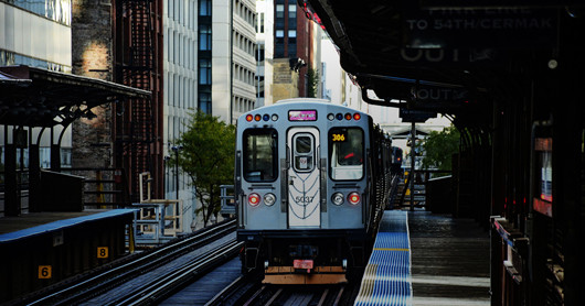 red line el train waiting at a platform
